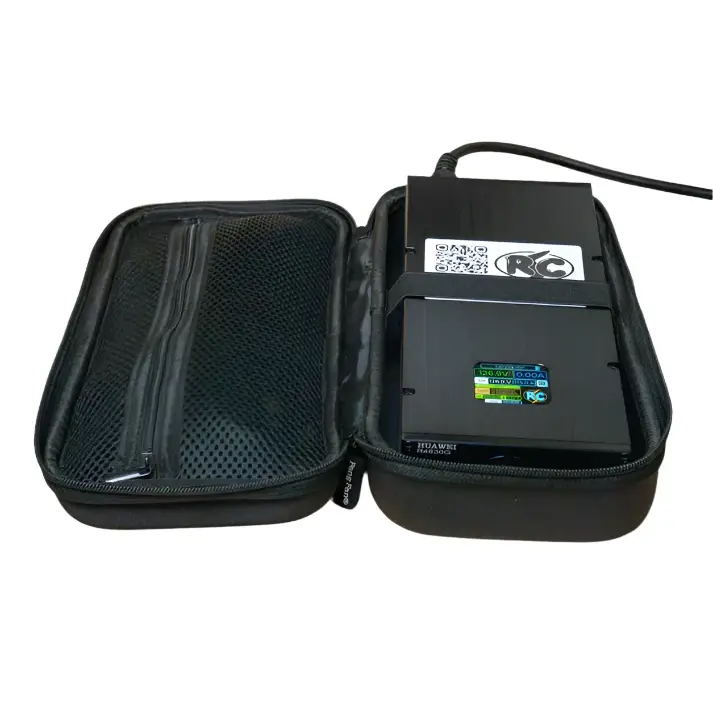 Charger device with black casing labeled Roger Charger SC, placed inside open black zippered carrying case with mesh pocket and connected power cable